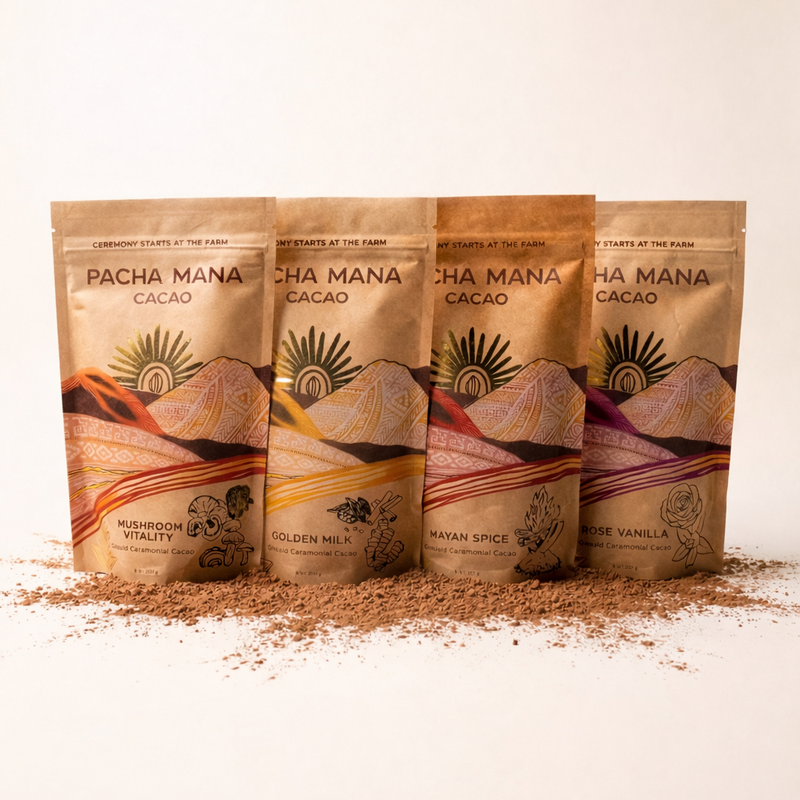 Four Pacha Manana cacao packages on a white background with cocoa powder.