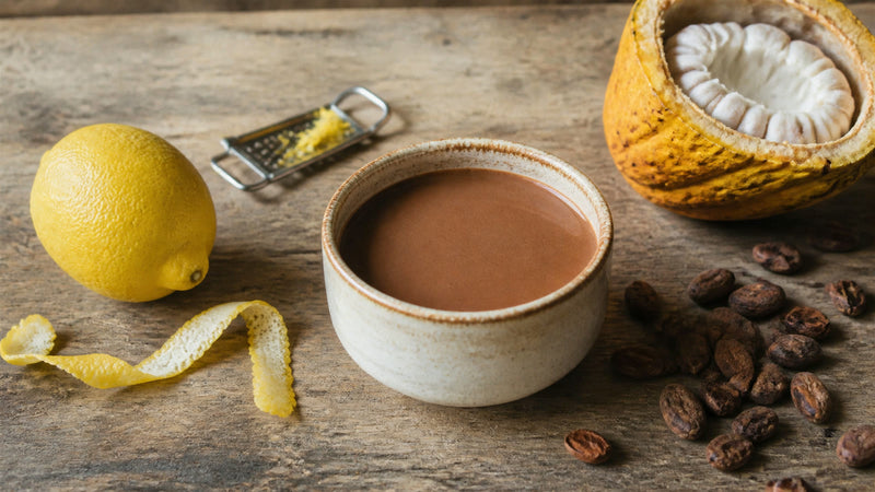Ceremonial cacao with a fresh lemon and curls of lemon zest